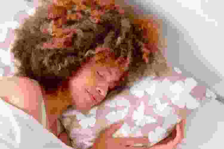 woman sleeping on satin pillowcase