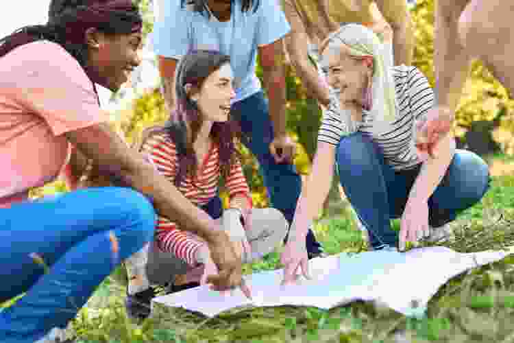 group of people studying scavenger hunt map