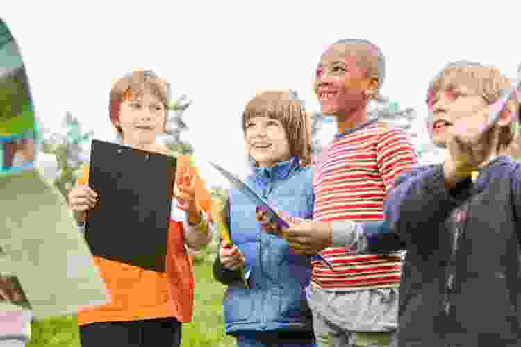 group of kids with papers for thanksgiving activity scavenger hunt