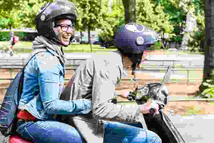 couple riding vespa