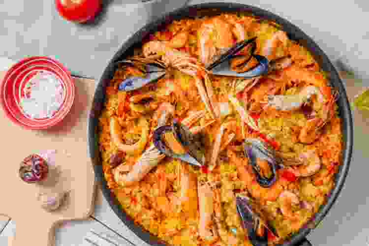 seafood paella in giant iron skillet