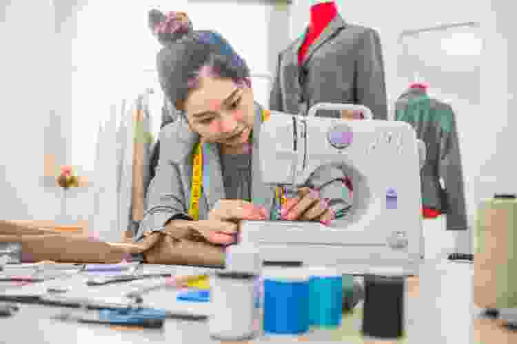 woman making clothes with sewing machine