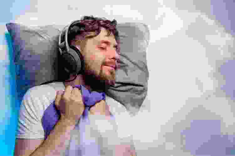 man sleeping in a cloud with headphones