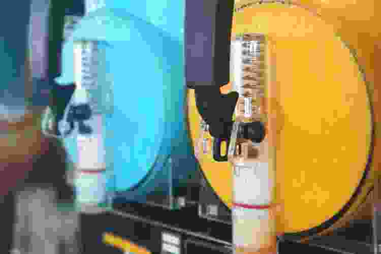 bright blue and yellow slushy drinks in drink machines