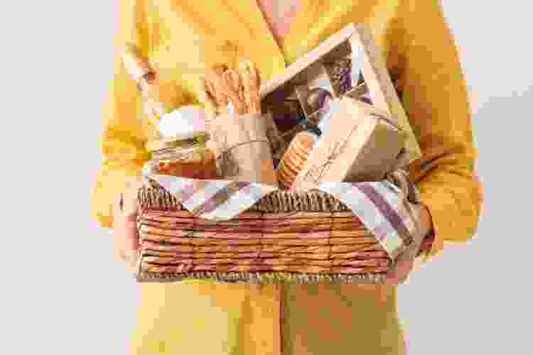 gift basket filled with bread, chocolate, wine and other snacks