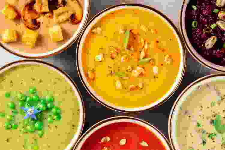 different colored soups in bowls