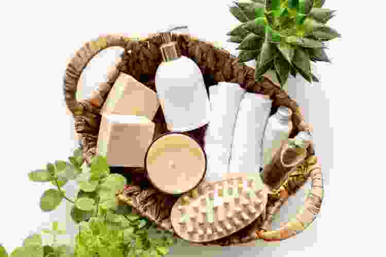 small basket filled with spa essentials like soap, salts and washcloths 