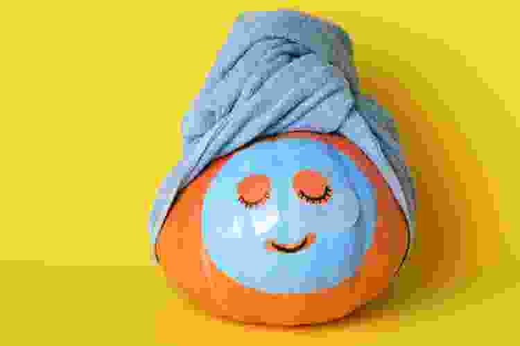 pumpkin wearing towel with painted mud mask for spa pumpkin