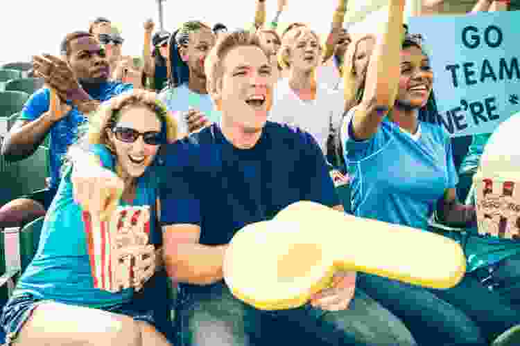 couple cheering in the stands of a sports game