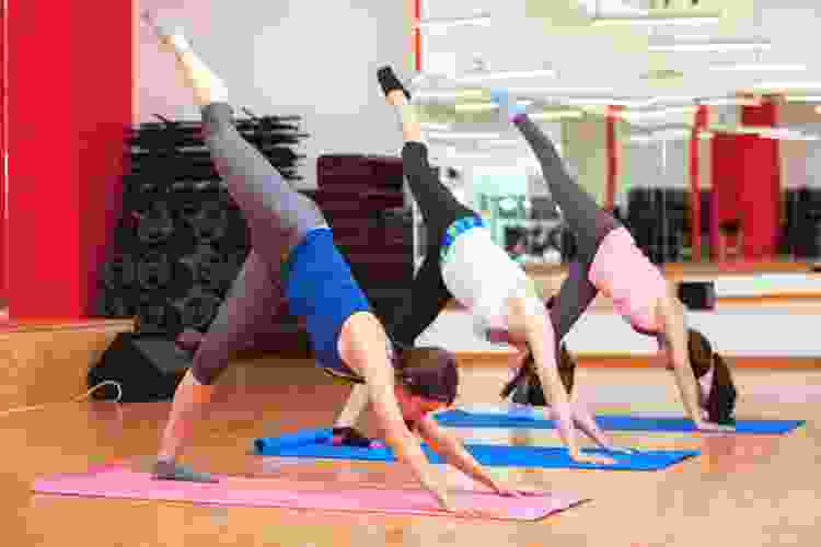 dance class of people doing standing splits stretch