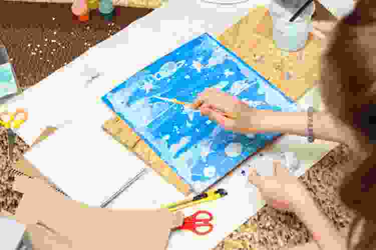 painting stars on canvas in art class