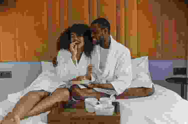 couple eating breakfast in bed