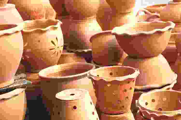 collection of handmade orange stoneware clay flower pots