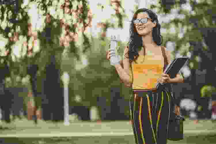 student drinking water on campus