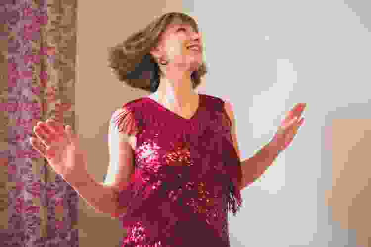 woman in red dress dancing by herself