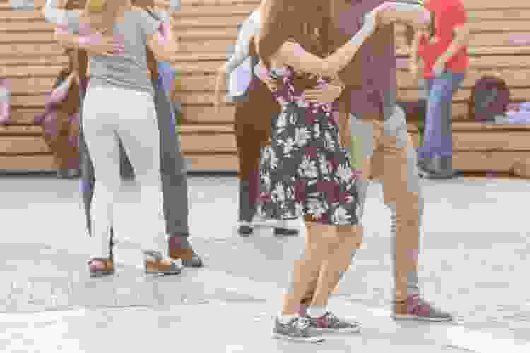 group of dancers learning salsa in town square