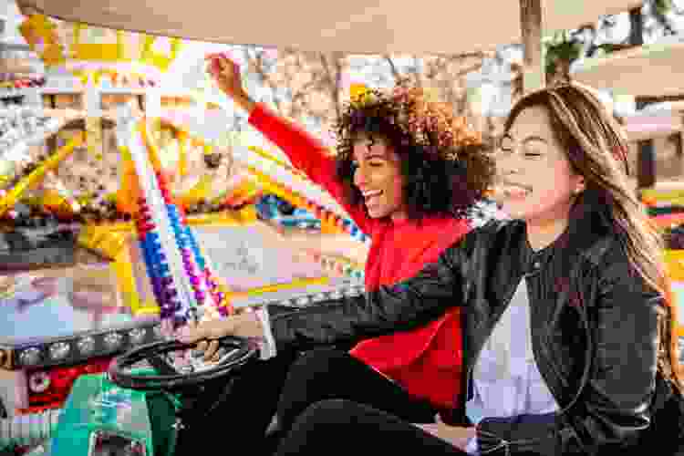 two young woman riding at theme park