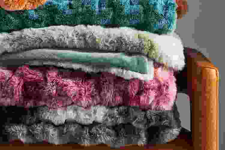 cozy throw blankets in a pile