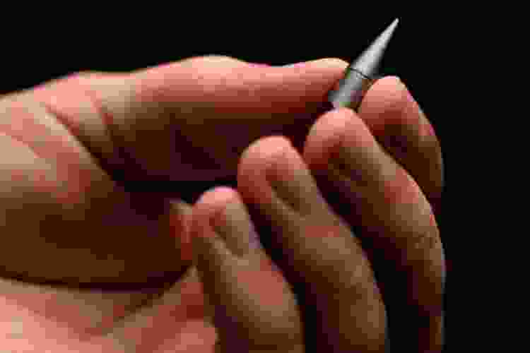 hand holding the world's tiniest inkless pen