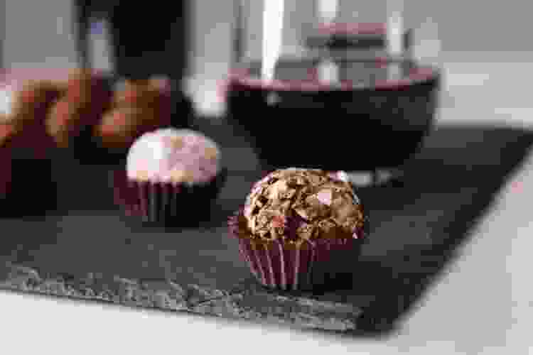 chocolate truffles on table next to wine