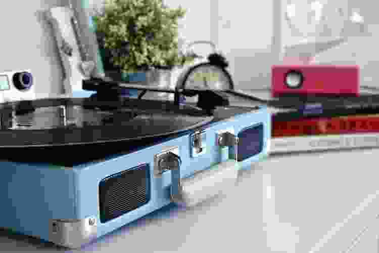 light blue vintage record player on white table