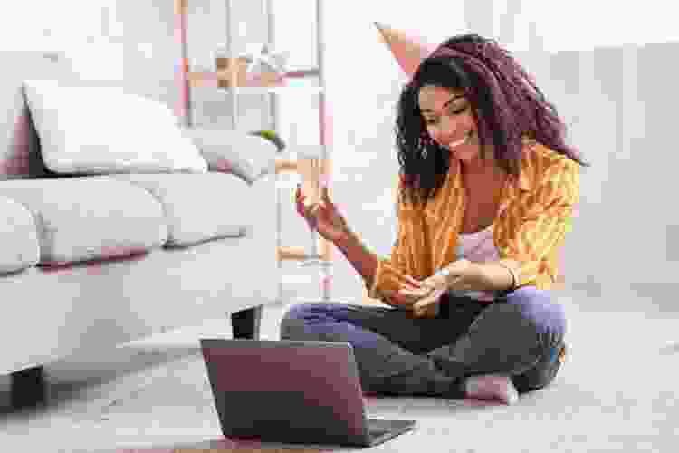 young woman in birthday hat and Champagne on laptop video call