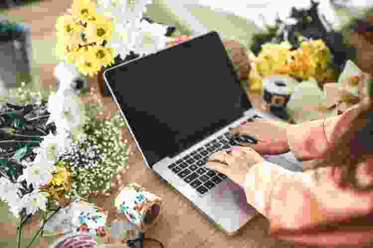 laptop surrounded by florals