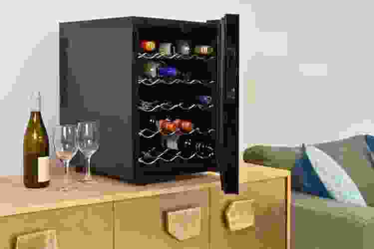 wine cooler on shelf with wine glasses and bottle