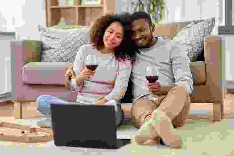 couple drinking wine with laptop