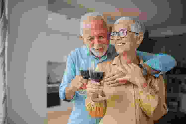 old couple drinking red wine together 