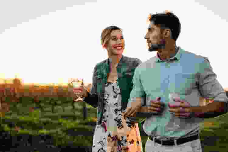 couple drinking wine at a vineyard as a spring date idea