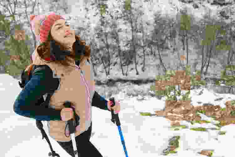 woman smiling on a snowy hike