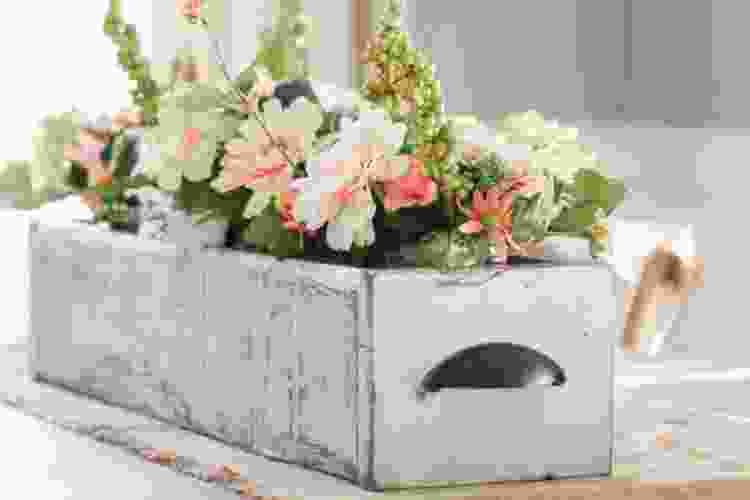 white wooden box filled with spring-colored flowers