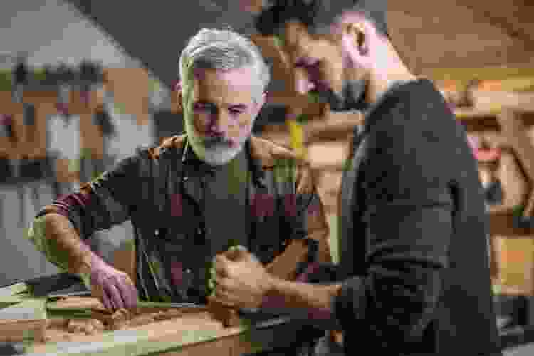 father and son in woodshop together