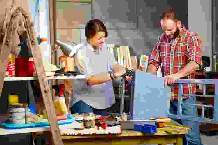 couple building chair together in woodshop