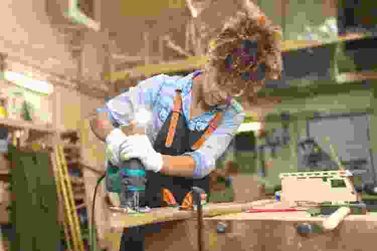 woman in woodshop making woodwork