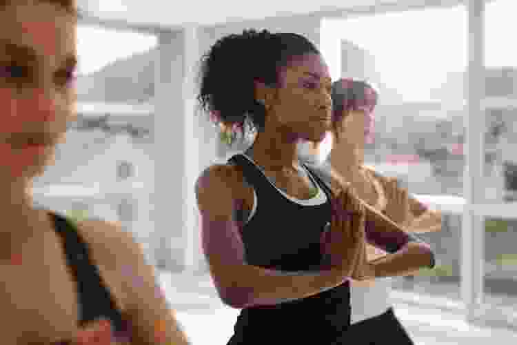 woman sitting in yoga pose in studio