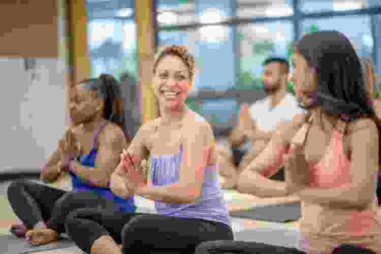 friends smiling during yoga class