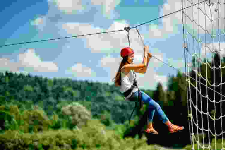 young woman riding zipline