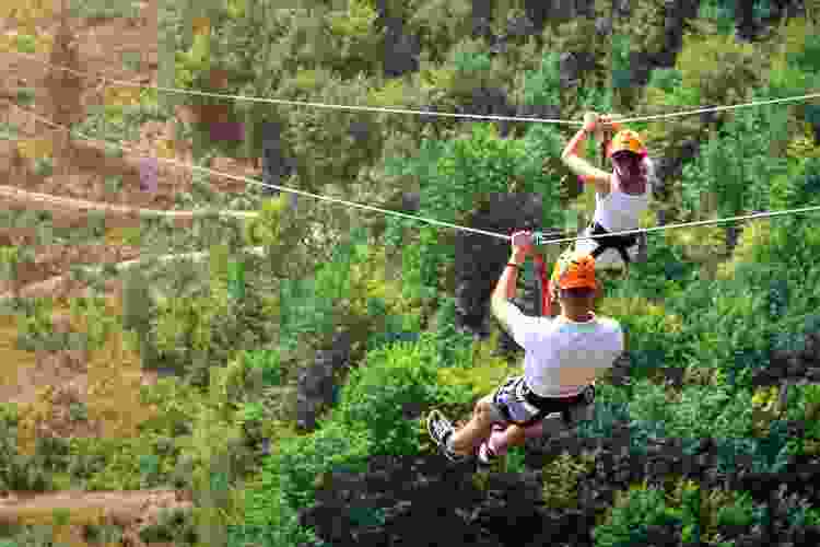 two people riding on zipline