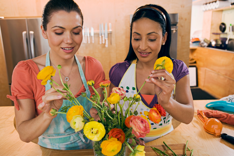 couple arranging flowers as stay home date idea