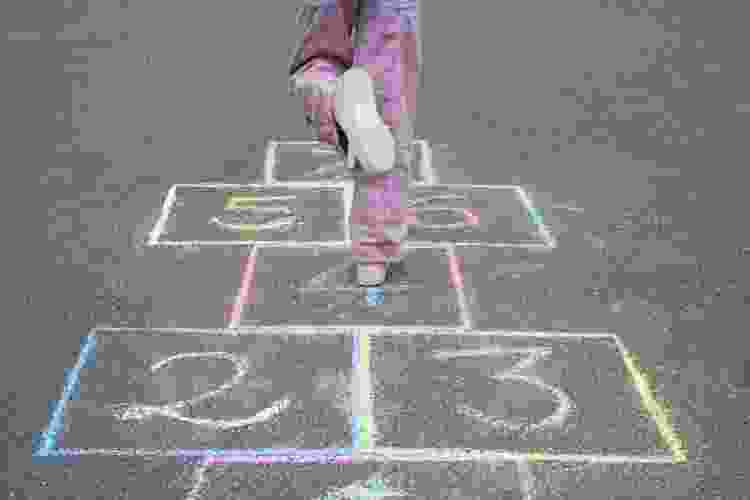 Girl playing Hop-scotch