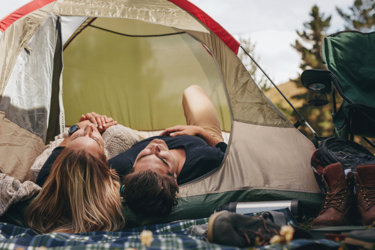Couple Camping in tent playing camping games