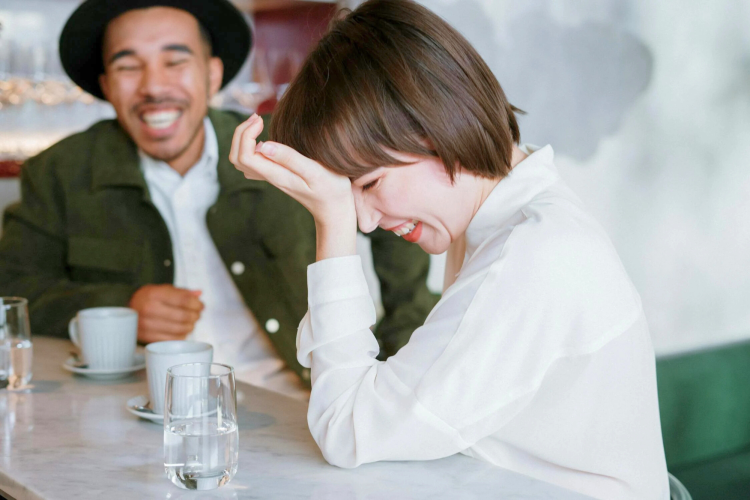 Diverse couple laughing in a cafe