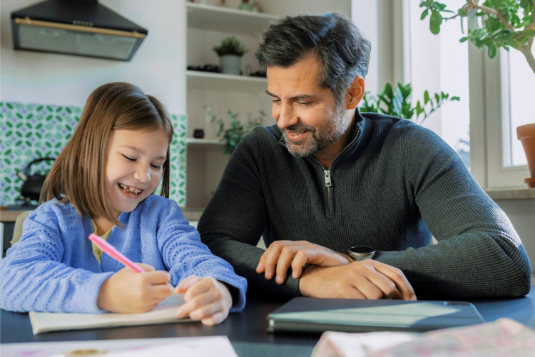 Dad doing homework with his daughter