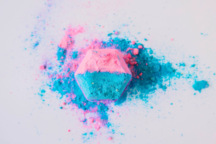elevated view pink blue colored bath bomb white background