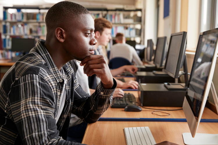 Male Student Studying during summer program for high school students