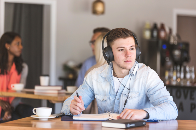 Male Student using coffee shop as place to study