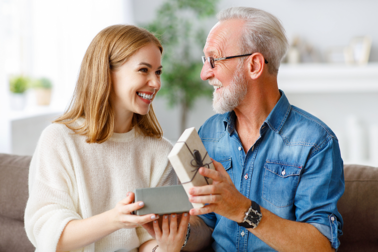 Adult Daughter giving Gift to Father