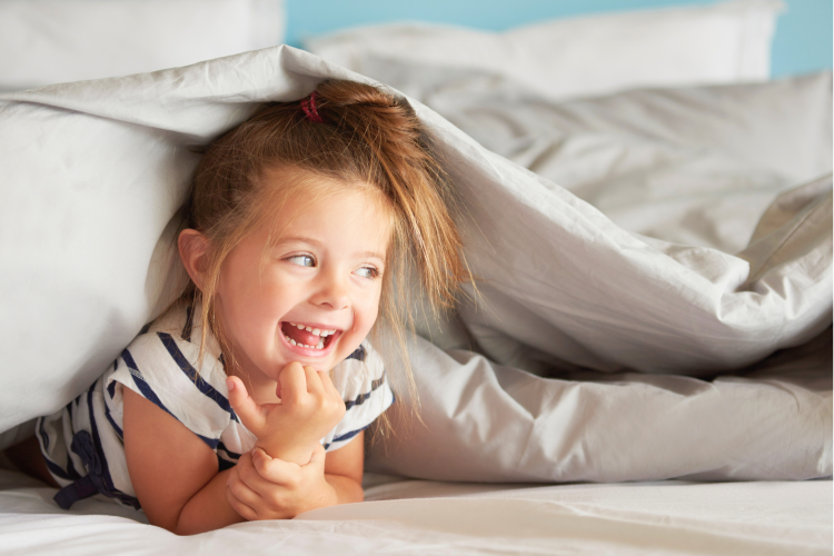 cheerful girl hiding sheets